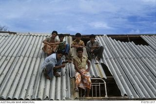 Boarding school roof awaiting repair, Pangi village, Lifuka Island. This image relates to the service of Michael Church, 17 Construction Squadron, who was a member of the Cyclone Isaac mission in ..
