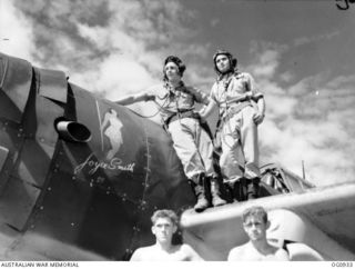 NADZAB, NEW GUINEA. C. 1944-02. FLIGHT SERGEANT NORM B. KELLETT, BRUNSWICK, VIC, AND HIS OBSERVER FLIGHT SERGEANT BRIAN "TUCK" P. TURNER, SNOWTOWN, SA, STAND ON THE WING OF THEIR VULTEE VENGEANCE ..