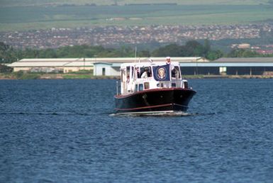 The barge of ADM Charles R. Larson, commander in chief, U.S. Pacific Command, transports President George Bush and Mrs. Bush toward the pier following their visit to the USS ARIZONA MEMORIAL. The president will present a speech as part of an observance commemorating the 50th anniversary of the Japanese attack on Pearl Harbor