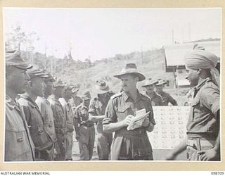 MISSION POINT, NEW GUINEA. 1945-11-09. JEMADAR CHINDT SINGH, INDIAN ARMY, ASSISTING MEMBERS OF THE WAR CRIMES COMMISSION DURING AN IDENTIFICATION PARADE OF SUSPECTED JAPANESE WAR CRIMINALS