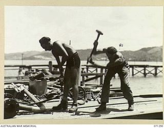 PORT MORESBY, PAPUA, 1944-03-21. VX84814 SAPPER J.L. KENNEDY (1) AND VX48143 SAPPER A.D. ROWE (2), MEMBERS OF NO.3 PLATOON, 2/16TH FIELD COMPANY, ROYAL AUSTRALIAN ENGINEERS, DRILLING HOLES AND ..