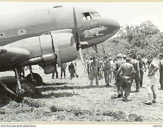 THE "SWAMP RAT", A DOUGLAS C47 AIRCRAFT OF THE UNITED STATES 5TH AIR FORCE, BOGGED IN THE SOFT GROUND AT THE END OF THE NEW AIRSTRIP