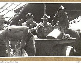 "THE SADDLE", SHAGGY RIDGE, NEW GUINEA. 1944-01-10. SUPPLIES ARRIVING AT B ECHELON, 2/9TH INFANTRY BATTALION, JUST BELOW THE 18TH INFANTRY BRIGADE HEADQUARTERS. HERE THEY ARE BROKEN UP INTO COMPANY ..