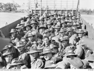 SIAR, NEW GUINEA. 1944-07-25. TROOPS OF THE 61ST INFANTRY BATTALION, CROWDED ABOARD A LANDING BARGE ON THE LAST LEG OF THEIR JOURNEY FROM MADANG AFTER DISEMBARKING FROM THE TRANSPORT SHIP (TS) ..