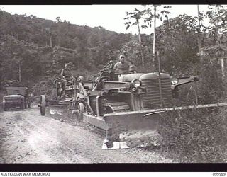 WAU-LABU ROAD, NEW GUINEA, 1946-01-08. A CHALMERS HD7 BULLDOZER TOWING A 12-FOOT DRAWER GRADER DURING GRADING OPERATIONS 6 MILES FROM BULOLO BY 8 MECHANICAL EQUIPMENT COMPANY, ROYAL AUSTRALIAN ..