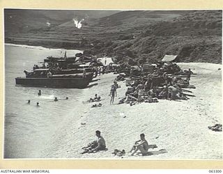 KANOMI BEACH, NEW GUINEA. 1944-01-04. TROOPS OF THE 9TH DIVISION ENJOY THE SWIMMING AND SUN BATHING WHILE AWAITING ORDERS TO MOVE FORWARD