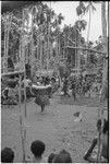 Mortuary ceremony, Omarakana: procession of mourning women carrying high-ranking fiber skirt valuables and large baskets, anthropologist Annette Weiner carries a banner