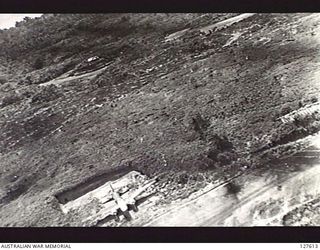 VUNAKANOU, NEW GUINEA. 1943-10-24. VIEW FROM FIFTH AIR FORCE, UNITED STATES ARMY AIR FORCE BOMBER OF "BETTYS" (JAPANESE AIRCRAFT) DISPERSED IN REVETMENTS. ATTACKING PLANES CAN BE SEEN COMING OVER ..