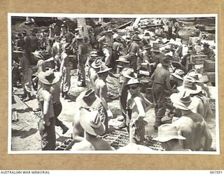 FINSCHHAFEN, NEW GUINEA. 1943-11-20. AUSTRALIAN TROOPS AT WORK SORTING STORES AT THE DUMP