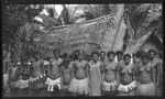 Trobriand women and girls outside a house