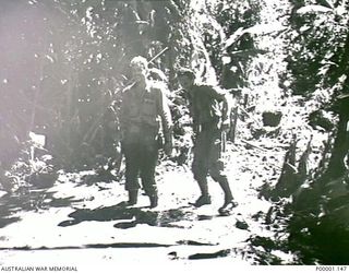 THE SOLOMON ISLANDS, 1945-05-02. TWO AUSTRALIAN SOLDIERS APPARENTLY ENJOYING PATROL DUTIES ON BOUGAINVILLE ISLAND. (RNZAF OFFICIAL PHOTOGRAPH.)