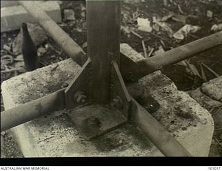 Lae, New Guinea. 1945-05-24. The base plate of a tubular steel column prefabricated tank stand sitting on a concrete slab supporting two 3,000 gallon water tanks