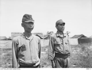 CAPE WOM, NEW GUINEA. 1945-10-19. LIEUTENANT TAZAKI (1) AND CORPORAL YAMAMOTO (2) MEMBERS OF THE JAPANESE ARMY WHO WERE QUESTIONED AT HEADQUARTERS 6 DIVISION BY THE WEWAK WAR CRIMES COMMISSION, ..