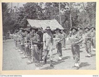 MOTUPENA POINT, BOUGAINVILLE, 1945-07-04. HIS ROYAL HIGHNESS, THE DUKE OF GLOUCESTER, GOVERNOR-GENERAL OF AUSTRALIA (1), INSPECTING THE BAND OF 29 INFANTRY BRIGADE WHILE VISITING THE AREA