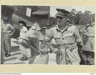 JACQUINOT BAY, NEW BRITAIN. 1945-04-21. MAJOR-GENERAL A.H. RAMSAY, GENERAL OFFICER COMMANDING 5 DIVISION (1), GREETS HIS SUCCESSOR, MAJOR-GENERAL H.C.H. ROBERTSON (2), AT JACQUINOT BAY AIRSTRIP