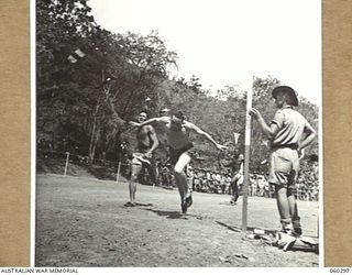 ELA BEACH, NEW GUINEA. 1943-11-13. FINISH OF THE 220 YARDS CHAMPIONSHIP AT THE COMBINED SERVICES SPORTS CARNIVAL, SHOWING FIRST, SECOND AND THIRD IN THE EVENT. THEY ARE: 118982 LEADING AIRCRAFTMAN ..