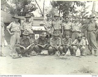 LAE, NEW GUINEA. 1944-12-30. SENIOR REPRESENTATIVE WYSHAM, AUSTRALIAN RED CROSS SOCIETY, AND A GROUP OF JAPANESE PRISONERS OF WAR TO WHOM HE HAS JUST GIVEN PARCELS OF COMFORTS