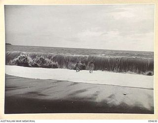 LAMARIEN, HENRY REID BAY, NEW BRITAIN, 1945-07-29. TWO MEMBERS OF 2/2 COMMANDO SQUADRON FROLLICKING IN THE HUGE BREAKERS NEAR THEIR CAMP