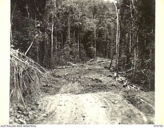 WAMPIT, NEW GUINEA. 1944-03-01. A SWAMPY, LOW-LYING, MUD CHURNED SECTION 66 1/2 MILES FROM WAU ON THE WAU - LAE ROAD. THE ROAD IS IN THE OPERATIONAL AREA OF THE HEADQUARTERS, COMMANDER ROYAL ..