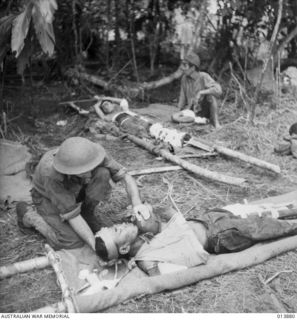 1942-12-17. PAPUA. FALL OF GONA. JAPANESE WOUNDED IN THE FINAL ASSAULT ON GONA RECEIVE MEDICAL ATTENTION