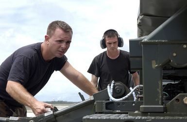 US Air Force (USAF) STAFF Sergeant (SSGT) John Beldin (left) and USAF SSGT Landon Favors both Weapons Loaders assigned to the 2nd Bomb Wing (BW), load a Conventional Air Launch Cruise Missile onto a USAF B-52H Stratofortress aircraft while deployed with the 7th Air Expeditionary Wing (AEW) at Andersen Air Force Base (AFB), Guam, during Operation ENDURING FREEDOM