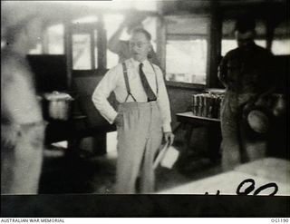 AITAPE, NORTH EAST NEW GUINEA. C. 1944-06. ARTHUR DRAKEFORD, THE MINISTER FOR AIR (CENTRE), AND JOHN DEDMAN, THE MINISTER FOR WAR ORGANISATION OF INDUSTRY (RIGHT), IN THE AIRMEN'S MESS DURING THE ..