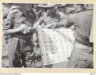 MISSION POINT, NEW GUINEA. 1945-11-09. FORMER INDIAN PRISONER OF WAR IDENTIFYING SUSPECTED JAPANESE WAR CRIMINALS DURING AN IDENTIFICATION PARADE ARRANGED BY THE WAR CRIMES COMMISSION