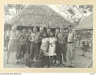 LAE, NEW GUINEA. 1944-10-18. NGX350 MAJOR E.W. JENYNS, DEPUTY ASSISTANT DIRECTOR OF NATIVE LABOUR AND OFFICER IN CHARGE, LAE BASE SUB AREA, AUSTRALIAN NEW GUINEA ADMINISTRATIVE UNIT (9) AND HIS ..