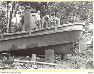 1943-04-20. NEW GUINEA. JAPANESE LANDING BARGES SUNK DURING AN UNSUCCESSFUL ATTACK HAVE NOW BEEN SALVAGED. THE BARGES ARE BEING REPAIRED FOR USE BY AUSTRALIAN FORCES. (NEGATIVE BY N. BROWN)