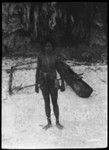 Man with canoe in the sand