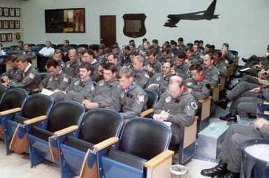 B-52G Stratofortress aircraft pilots of the 43rd Strategic Wing synchronize their watches before an aerial mining mission over South Korea during Exercise TEAM SPIRIT '85