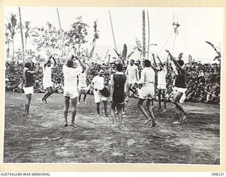 KARAVIA BAY, NEW BRITAIN. 1945-10-23. MAJOR GENERAL K.W. EATHER, GENERAL OFFICER COMMANDING 11 DIVISION, VISITED THE INDIAN EX-PRISONER OF WAR CAMP AT KARAVIA BAY. SHOWN, AN INDIAN FOLK DANCE, THE ..