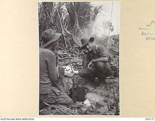 KIARIVU, NEW GUINEA, 1945-08-07. LIEUTENANT P.K. PARBURY, COMMANDING OFFICER OF THE BATTLE FORCE OF 2/7 INFANTRY BATTALION TROOPS, ISSUING INSTRUCTIONS FOR THE REAR ECHELONS TO MOVE FORWARD TO ..