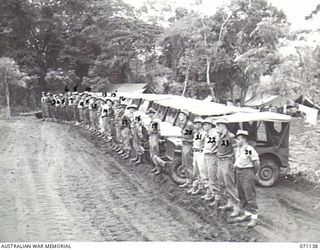 KILIGIA, NEW GUINEA, 1944-03-12. DRIVERS OF THE 5TH DIVISION TRANSPORT SECTION LINES IN FRONT OF THEIR JEEPS DURING THE MORNING PARADE. IDENTIFIED PERSONNEL ARE: QX45493 DRIVER J.T. O'SHEA (1); ..