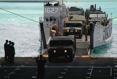 A view from inside the dell deck onboard the US Navy (USN) Dock Landing Ship, USS HARPERS FERRY (LSD 49), showing Sailors up loading vehicles for the US Marine Corps (USMC) 31st Marine Expeditionary Unit (MEU), at Apra Harbor, Guam, from the USN Landing Craft Utility (LCU 1627), following a Spring Patrol. (Duplicate image, see also 060209-N-4772B-237 or DN-SD-06-10103)