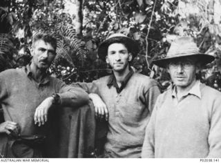 Kokoda Track, Papua. 1942. Informal portrait of Warrant Officer 2 Honeywell (left), Captain Swinton (middle) and Padre McCabe, Salvation Army chaplain (right), in the jungle. (Original housed in ..