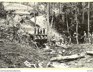 KILIGIA AREA, NEW GUINEA, 1944-03-16. TROOPS OF THE 8TH FIELD COMPANY, ROYAL AUSTRALIAN ENGINEERS, WORKING ON A 60 FEET TIMBER TRESTLE BRIDGE ABOUT A MILE SOUTH OF KILIGIA. THE BRIDGE WILL BE ..