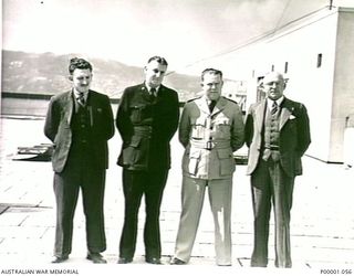 THE SOLOMON ISLANDS, 1945-02-17. FOUR MEMBERS OF THE AUSTRALIAN CIVIL AVIATION COMMISSION. (RNZAF OFFICIAL PHOTOGRAPH.)