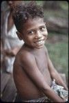 Child sits on the veranda of the Hutchins' house