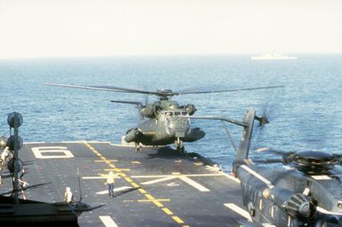 A CH-53 Sea Stallion helicopter lands on the aft flight deck of the amphibious assault ship USS GUAM (LPH-9) during flight operations off the coast of Beirut, Lebanon