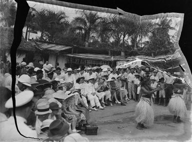 [A crowd watching a Pacific Island performance]