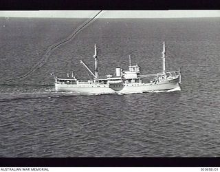 1941-02-10. AERIAL STARBOARD SIDE VIEW OF THE BRITISH CARGO VESSEL MV MULIAMA WHICH, WITH OTHER SMALL VESSELS, RAN A SHUTTLE SERVICE BETWEEN CAIRNS AND DARWIN FROM 1942-03 AND LATER SERVED IN NEW ..