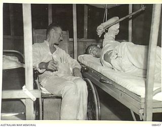 FINSCHHAFEN, NEW GUINEA. 1945-04-04. LEADING AIRCRAFTMAN S.S. GLUCK, 17 STORES UNIT RAAF, (1) WITH WARRANT OFFICER J.D. SUTTON, (2) AIR GUNNER USAAF, WHO SUFFERED A BROKEN BACK, WHEN A DOUGLAS C 47 ..