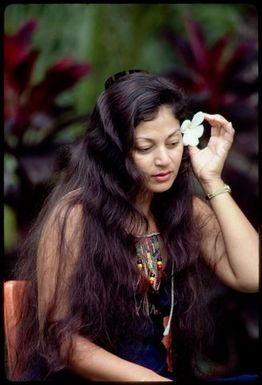 Woman with frangipani in her hair