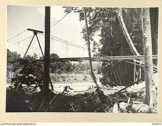 LAE, NEW GUINEA. 1944-10-18. A WATERPIPE CROSSING THE BUSU RIVER BY THE NEW BRIDGE. THE PIPELINE WHICH CARRIES WATER TO THE 2/7TH AUSTRALIAN GENERAL HOSPITAL, THE BRIDGE AND THE RESERVOIR WERE ALL ..