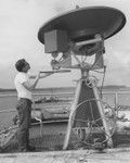 New Satellite weather Antenna-Principal Electronics Technician David Havens turns the wheel which adjusts vertical angle on the new satellite weather antenna installed aboard D/V Glomar Challenger during the port call at Agana, Guam, between legs 59 and 60 of the Deep Sea Drilling Project. The big wheel at the bottom takes care of the horizonal and vertical antenna angles. Information is received from a satellite in stationary orbit and processed by shipboard equipment to produce a weather map which enables the captain, scientists and operations personnel to get weather forecasets 18 hours in advance at any drilling and core site