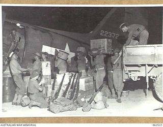 WARD'S DROME, PORT MORESBY AREA, PAPUA, NEW GUINEA. 1944-01-06. MEMBERS OF NO. 5 PLATOON, (PIONEERS) 57/60TH AUSTRALIAN INFANTRY BATTALION TRANSFERRING STORES FROM A TRUCK TO AN AIRCRAFT AT WARD'S ..