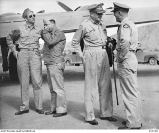 1943-07-07. NEW GUINEA. PACIFIC OFFENSIVE. GENERAL DOUGLAS MACARTHUR WHO IS COMMAND OF THE ALLIED OFFENSIVES IN NEW GUINEA AND THE SOLOMONS, PHOTOGRAPHED BESIDE HIS PLANE IN NEW GUINEA. WITH HIM IS ..