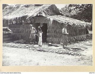 BUKA ISLAND, BOUGAINVILLE AREA, 1945-09-19. THE SWORDS OF JAPANESE OFFICERS, EACH WITH A NAME TAG, LAID OUT AROUND THE STORE HOUSE IN READINESS FOR COLLECTION BY THE AUSTRALIAN SURRENDER PARTY FROM ..