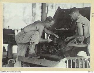 TOROKINA, BOUGAINVILLE. 1945-04-28. CRAFTSMAN F.L. PARKER (1), AND CRAFTSMAN A.J. STANLEY (2), WORKING ON A JEEP AT THE TRANSPORT AND LIGHT AID DETACHMENT SECTION ATTACHED HEADQUARTERS 2 CORPS